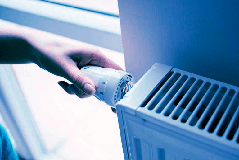 Setting the temperature on a radiator dial. All American Heating specializes in the hydronic heating systems common in Colorado's High Country