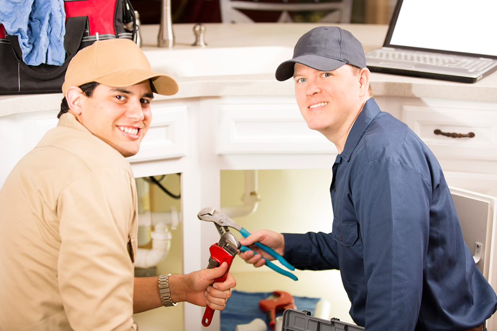 A Master Plumber trains an apprentice on the finer points