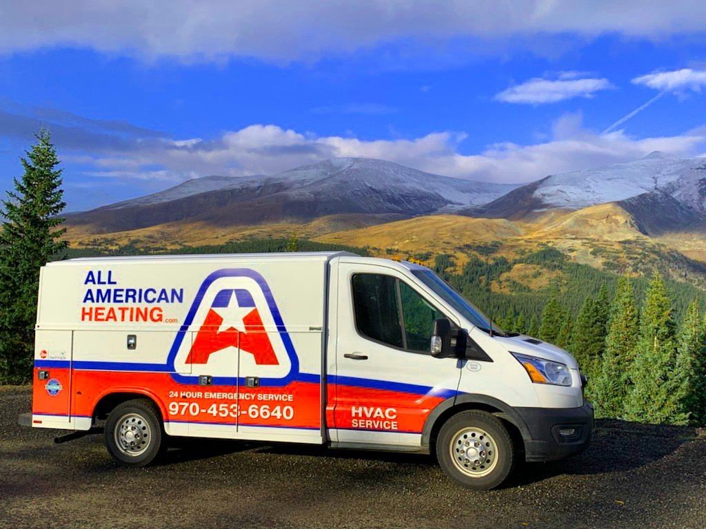 All American Heating work truck shines against mountain backdrop