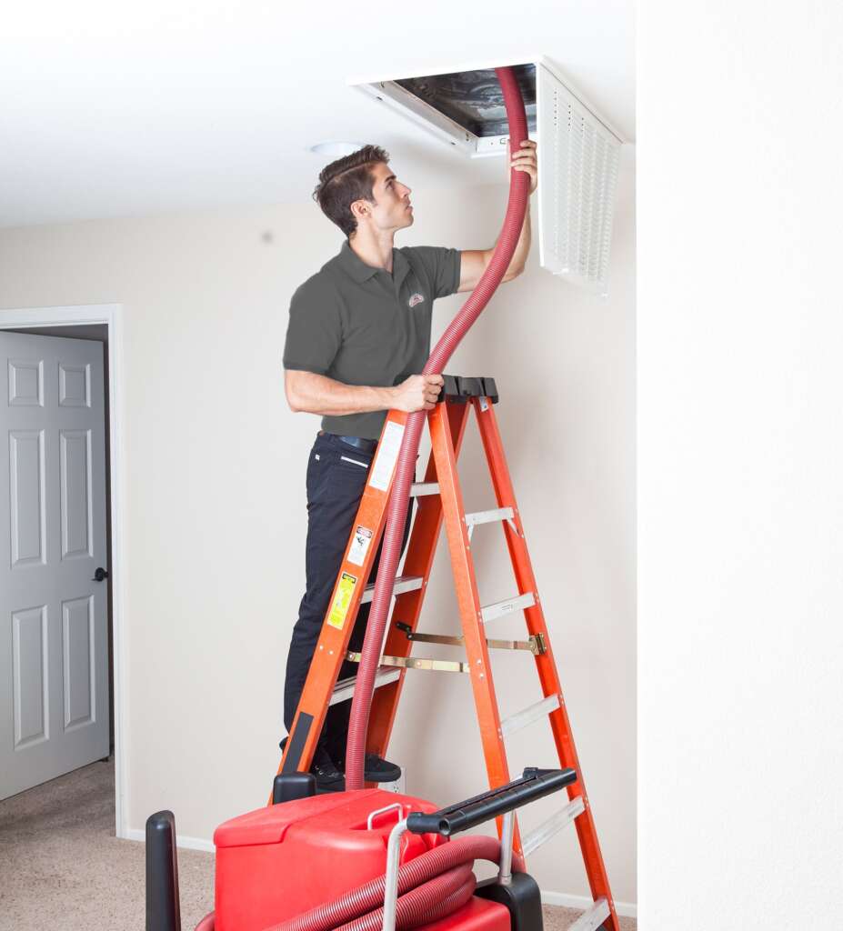 All American Heating Service Technician cleans ductwork at a customer's home